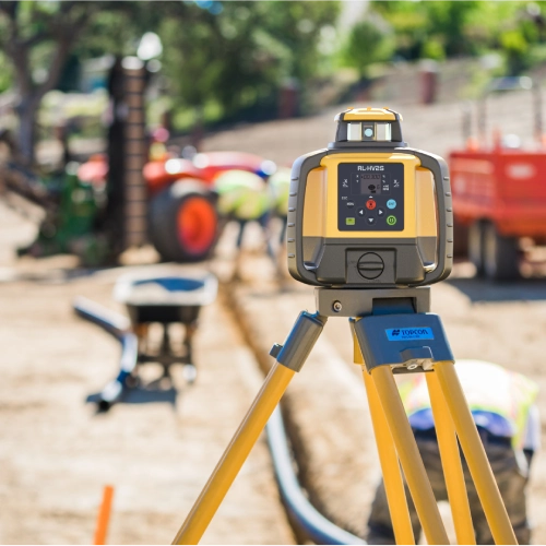 Surveyor operating a total station on a construction site
